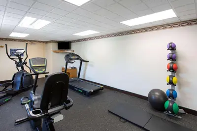 a gym with several exercise equipment in a room at Days Inn by Wyndham Hillsborough in Hillsborough