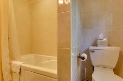 a bathroom with a toilet and a bath tub at Pools, Hot Tub and More Bushkill Mountain Getaway! in Sandyville
