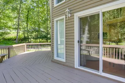 a screened porch with a glass door on a house at Pools, Hot Tub and More Bushkill Mountain Getaway! in Sandyville