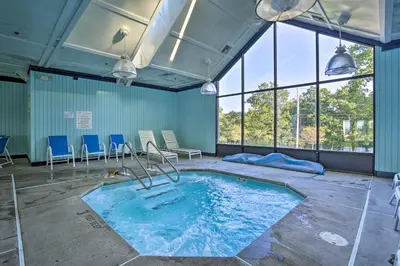 a large swimming pool in a room with windows at Pools, Hot Tub and More Bushkill Mountain Getaway! in Sandyville