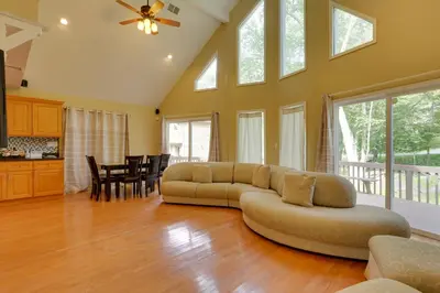 a living room with a couch and a table at Pools, Hot Tub and More Bushkill Mountain Getaway! in Sandyville