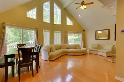 a living room with a couch and a table at Pools, Hot Tub and More Bushkill Mountain Getaway! in Sandyville