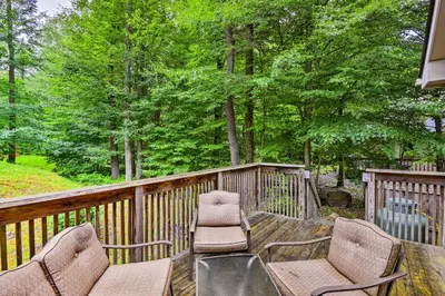 a deck with two chairs and a table and chairs at Walk to Beach Beautiful Lake Naomi Retreat! in Pocono Pines