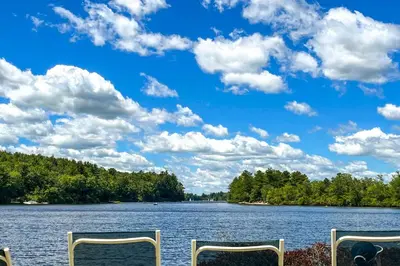 a view of a large lake with two chairs at Walk to Beach Beautiful Lake Naomi Retreat! in Pocono Pines