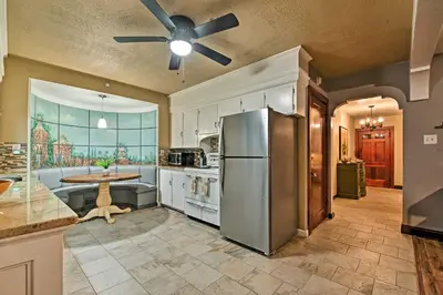 a kitchen with a stainless steel refrigerator and a table at Historic Stone Cottage with Firepit-Walk to Lily Lake in Wapwallopen