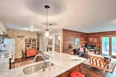 a kitchen and living room with a counter top at Relaxing Eagle Rock Resort Home - 1 Block to Lake! in Hazleton