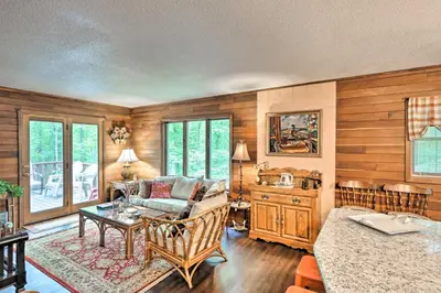 a living room with a couch and a table at Relaxing Eagle Rock Resort Home - 1 Block to Lake! in Hazleton