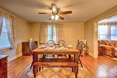 a dining room with a table and a ceiling fan at Whimsical Lancaster Home - 4 Mi to Sight and Sound in Lancaster