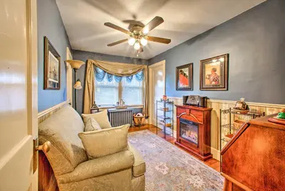 a living room with a couch and a ceiling fan at Whimsical Lancaster Home - 4 Mi to Sight and Sound in Lancaster