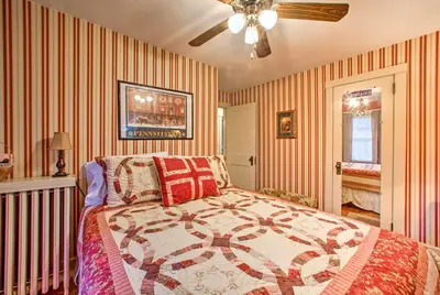 a bedroom with a bed and a ceiling fan at Whimsical Lancaster Home - 4 Mi to Sight and Sound in Lancaster