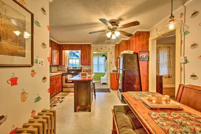 a kitchen with a dining table and a refrigerator at Whimsical Lancaster Home - 4 Mi to Sight and Sound in Lancaster