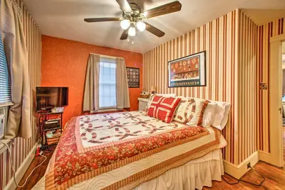 a bedroom with a bed and a ceiling fan at Whimsical Lancaster Home - 4 Mi to Sight and Sound in Lancaster