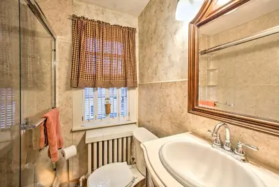 a bathroom with a sink and a toilet and a window at Whimsical Lancaster Home - 4 Mi to Sight and Sound in Lancaster