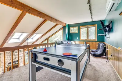 a ping pong table in a tiny house at Lake Harmony Resort Home with Deck and Fire Pit! in Lake Harmony