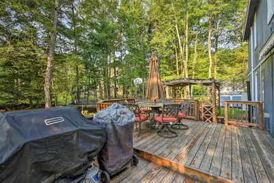 a wooden deck with a table and a tent at Lake Harmony Resort Home with Deck and Fire Pit! in Lake Harmony