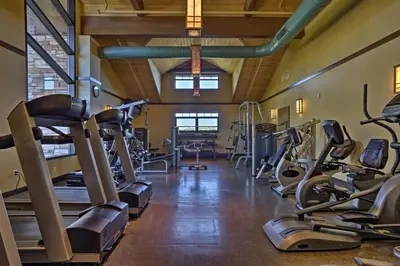 a gym with treadmills and elliptical machines at Creekside Arrowhead Lake House with Dock and Canoe! in Pocono Lake