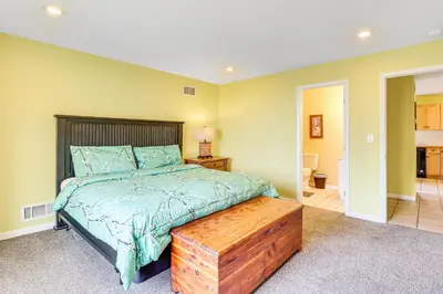a bedroom with a bed with a wooden head board at Pocono Retreat Access to Community Lake and Beach! in Albrightsville