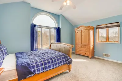 a bedroom with a bed and a dresser and a window at Pocono Retreat Access to Community Lake and Beach! in Albrightsville