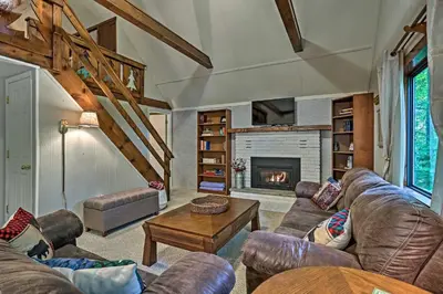 a living room with a couch and a fireplace at Pocono Lake House Near Skiing and Kalahari Resort! in Pocono Lake