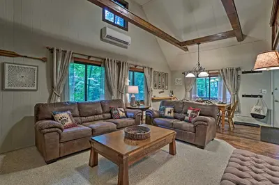 a living room with couches and a coffee table at Pocono Lake House Near Skiing and Kalahari Resort! in Pocono Lake