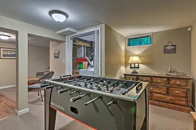 a living room with a foosball table at Pocono Lake House Near Skiing and Kalahari Resort! in Pocono Lake