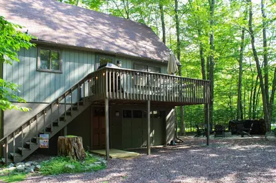 a house with a deck on the side of it at Pocono Lake House Near Skiing and Kalahari Resort! in Pocono Lake