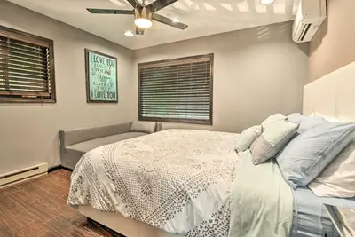a bedroom with a bed and a ceiling fan at Hot Tub and Fire Pit Waterfront Lake Harmony Home in Lake Harmony
