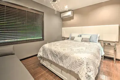 a bedroom with a bed and a window at Hot Tub and Fire Pit Waterfront Lake Harmony Home in Lake Harmony