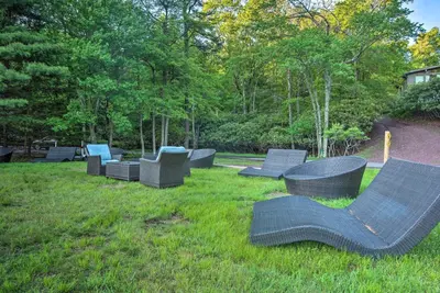a group of chairs sitting in the grass at Hot Tub and Fire Pit Waterfront Lake Harmony Home in Lake Harmony