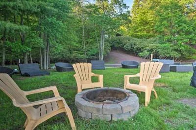 three chairs sitting around a fire pit in a yard at Hot Tub and Fire Pit Waterfront Lake Harmony Home in Lake Harmony