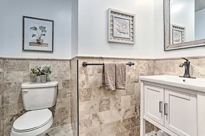 a bathroom with a toilet and a sink at Pocono Lake Paradise with Private Beach and Dock! in Pocono Lake
