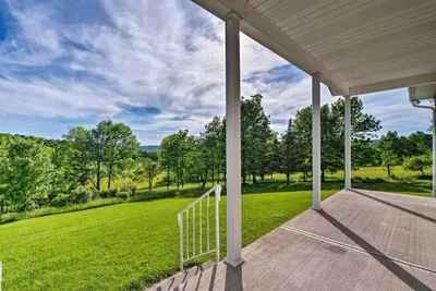 a porch of a home with a view of a green field at Private Dog-Friendly Home 3 Mi to Elk Mountain in Union Dale