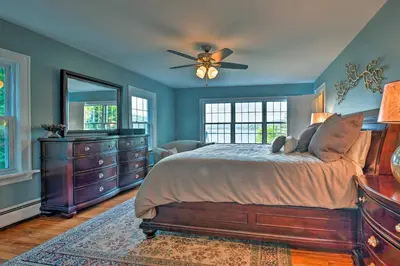 a bedroom with a bed and a ceiling fan at Waterfront Harveys Lake House with Private Dock! in Harveys Lake