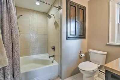 a bathroom with a toilet and a tub and a sink at Waterfront Harveys Lake House with Private Dock! in Harveys Lake