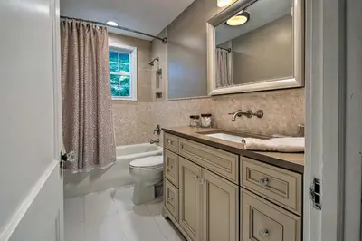 a bathroom with a sink and a toilet and a mirror at Waterfront Harveys Lake House with Private Dock! in Harveys Lake