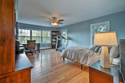 a bedroom with a bed and a ceiling fan at Waterfront Harveys Lake House with Private Dock! in Harveys Lake