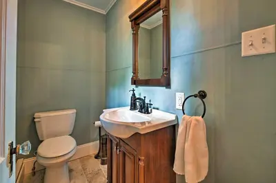 a bathroom with a sink and a toilet and a mirror at Waterfront Harveys Lake House with Private Dock! in Harveys Lake