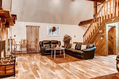 a living room with two leather couches and a table at Lake Harmony Vacation Rental with Hot Tub and Views! in Lake Harmony