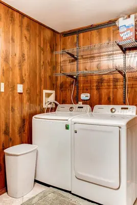 a washer and dryer in a bathroom with wooden walls at Lake Harmony Vacation Rental with Hot Tub and Views! in Lake Harmony