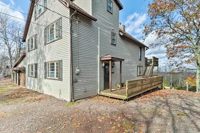 an old house with a porch on the side of it at Lake Harmony Vacation Rental with Hot Tub and Views! in Lake Harmony