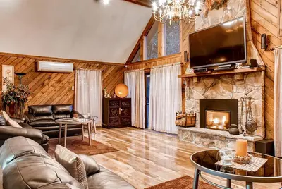 a living room with a couch and a fireplace at Lake Harmony Vacation Rental with Hot Tub and Views! in Lake Harmony