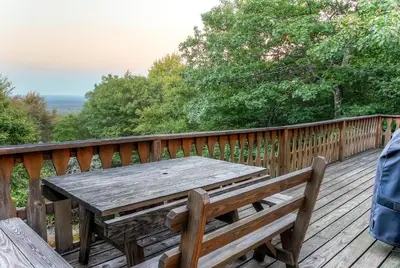 a wooden table and bench on a wooden deck at Lake Harmony Vacation Rental with Hot Tub and Views! in Lake Harmony