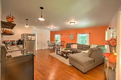 a living room with a couch and a kitchen at Cottage with Hot Tub and Fire Pit By Mahantango Creek in Dalmatia