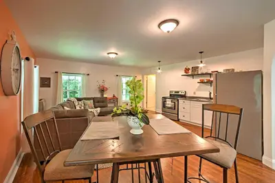 a kitchen and living room with a table and a couch at Cottage with Hot Tub and Fire Pit By Mahantango Creek in Dalmatia