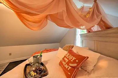 a bed with a tray of food on it at Cottage with Hot Tub and Fire Pit By Mahantango Creek in Dalmatia
