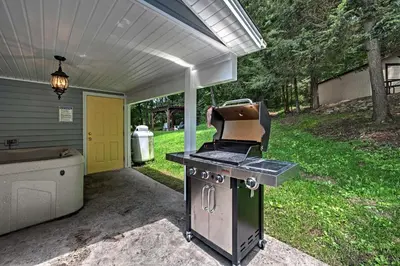 a barbecue grill in the back of a house at Cottage with Hot Tub and Fire Pit By Mahantango Creek in Dalmatia