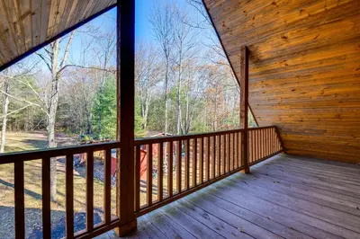 a view from the porch of a cabin with a large window at Benton Home on 50 Acres with Private Deck and Views! in Benton