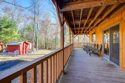 a wooden porch with chairs on a house at Benton Home on 50 Acres with Private Deck and Views! in Benton