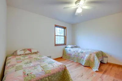 a bedroom with two beds and a ceiling fan at Benton Home on 50 Acres with Private Deck and Views! in Benton
