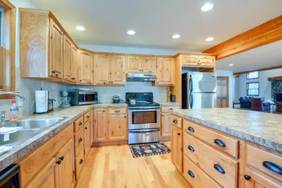 a kitchen with wooden cabinets and stainless steel appliances at Benton Home on 50 Acres with Private Deck and Views! in Benton